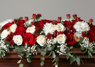 White & Red Rose Coffin Funeral Spray placed on a coffin